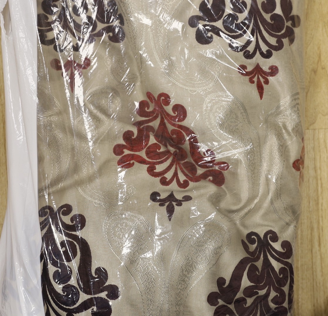 A large pair of silver brocaded curtains, with a woven paisley tear drop motif and large all over plum cut velvet Fleur-de-lis motifs, together with matching corded and tasselled tie backs.